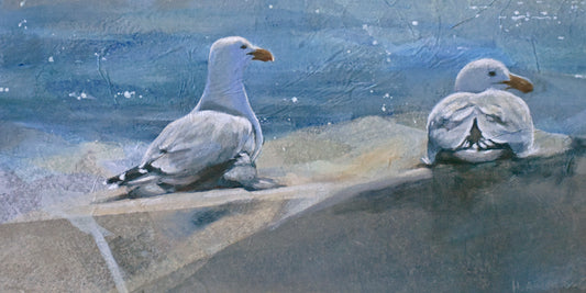 A painted scene showing two seagulls on a rocky shoreline against a blue water background. Features strong paper texture.